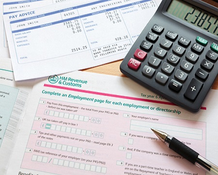 Photo of a UK self assessment tax return with calculator and pay